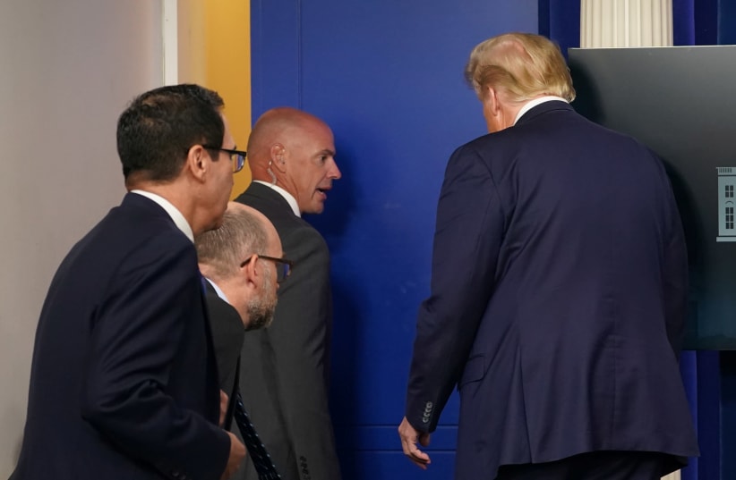 US President Donald Trump leaves a coronavirus disease (COVID-19) pandemic briefing at the White House in Washington, US, August 10, 2020. (photo credit: KEVIN LAMARQUE/REUTERS)