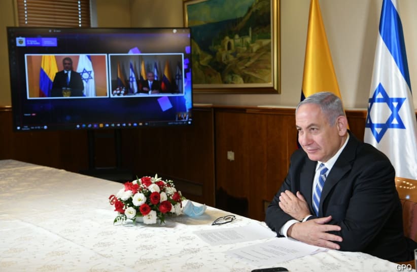 Prime Minister Benjamin Netanyahu and Colombia President Ivan Marquez meet by video (photo credit: AMOS BEN GERSHOM, GPO)
