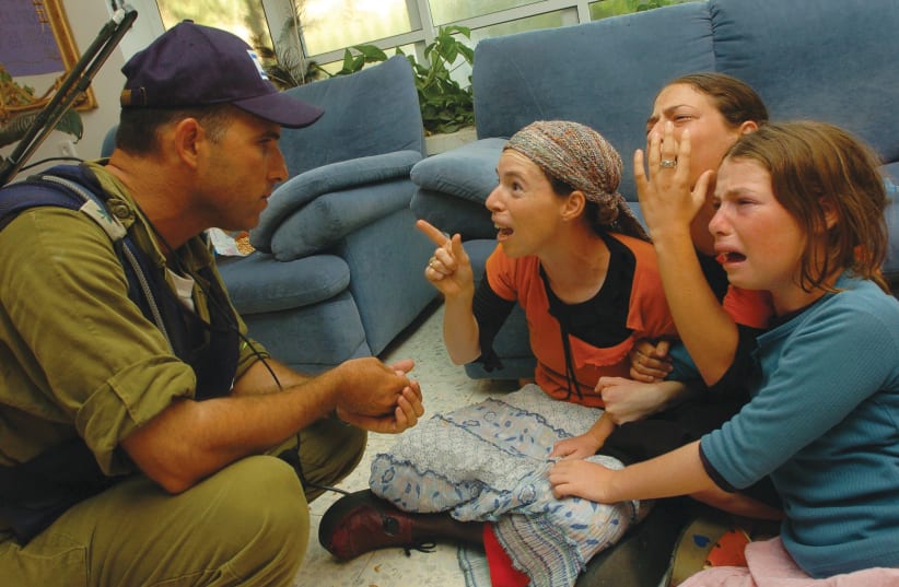 AN IDF soldier evicts residents from their Neveh Dekalim home on August 18, 2005 (photo credit: FLASH90)
