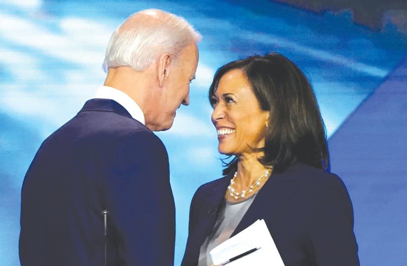 FORMER VICE President Joe Biden and Senator Kamala Harris greet each other before a Democratic primary debate last year. (photo credit: MIKE BLAKE/REUTERS)
