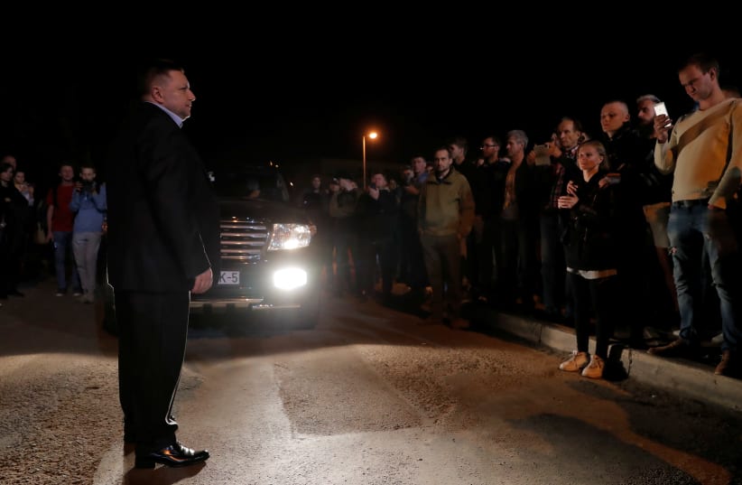 Belarus' Deputy Interior Minister Aleksandr Barsukov speaks to people outside a detention center, following recent protests against the presidential election results in Minsk, Belarus August 14, 2020. (photo credit: VASILY FEDOSENKO / REUTERS)