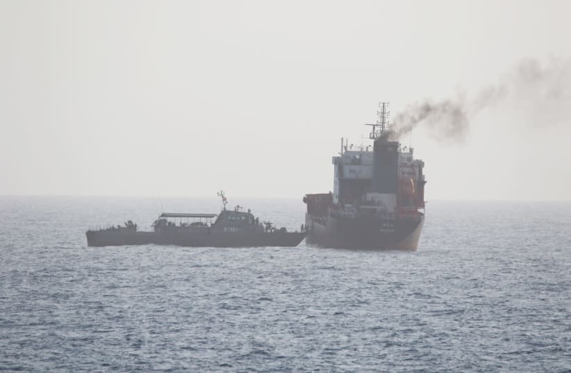 This picture released by the U.S. Navy allegedly shows a ship of the Iranian Navy and members of the Iranian forces boarding civilian tanker WILA en-route to the UAE, in international waters in the Strait of Hormuz, August 12, 2020. Picture taken on August 12, 2020 (photo credit: US NAVY/HANDOUT VIA REUTERS)