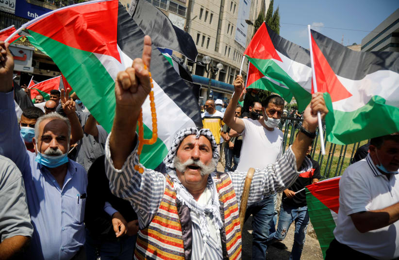 Palestinians take part in a protest against the United Arab Emirates' deal with Israel to normalise relations, in Nablus in the Israeli-occupied West Bank August 14, 2020 (photo credit: REUTERS/RANEEN SAWAFTA)