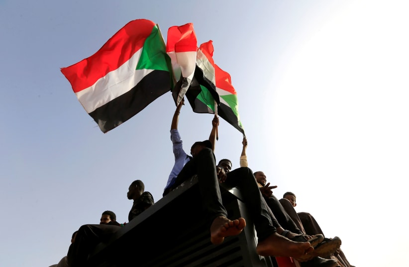 Sudanese protesters shout slogans and wave flags during a rally honouring fallen protesters at the Green Square in Khartoum, Sudan July 18, 2019 (photo credit: REUTERS/ MOHAMED NURELDIN ABDALLAH)