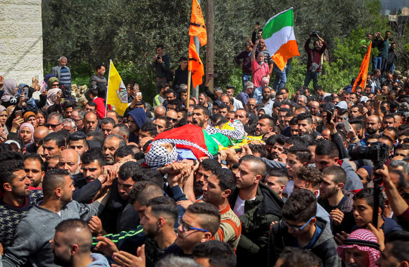 Palestinians carry the body of Ahmad Jamal Manasra during his funeral ceremony in the West Bank village of Wad Fokin, near Bethlehem on March 21, 2019 (photo credit: WISAM HASHLAMOUN/FLASH90)