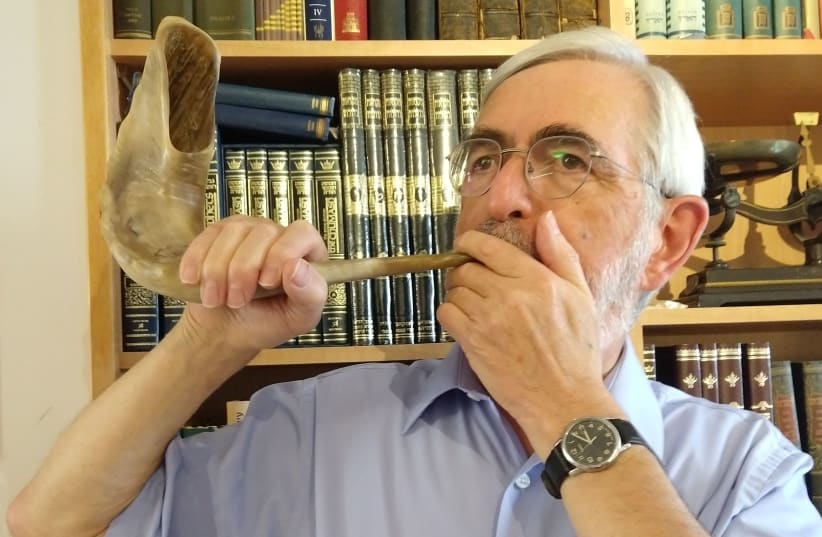 THE WRITER demonstrates how to hold the shofar. (photo credit: DAVID OLIVESTONE)