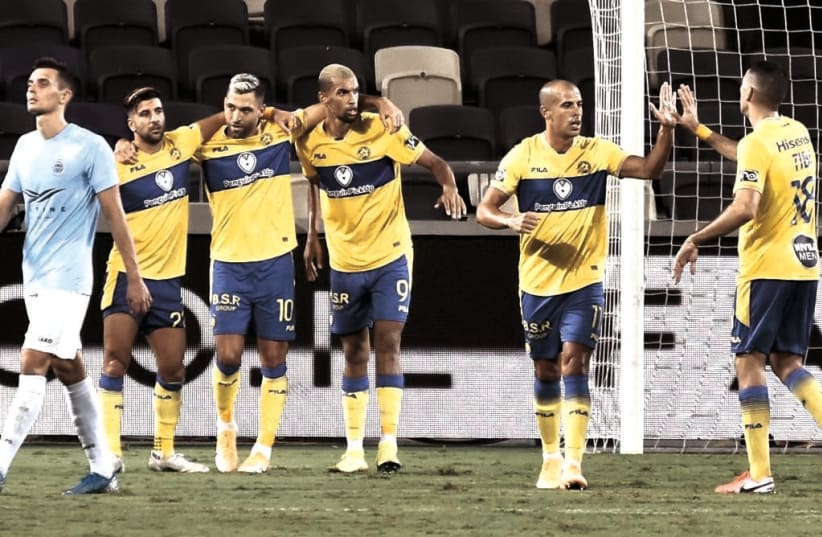 MACCABI TEL AVIV players celebrate their second goal in Wednesday night’s 2-0 conquest of Riga FC in Champions League qualifying at Bloomfield Stadium (photo credit: DOV HALICKMAN PHOTOGRAPHY)