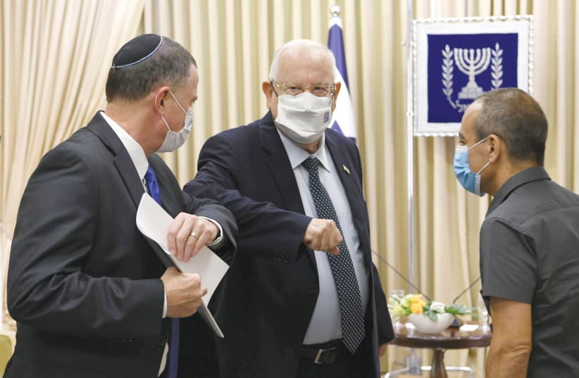 PRESIDENT REUVEN RIVLIN is seen greeting Heath Minister Yuli Edelstein. (photo credit: AMOS BEN-GERSHOM/GPO)