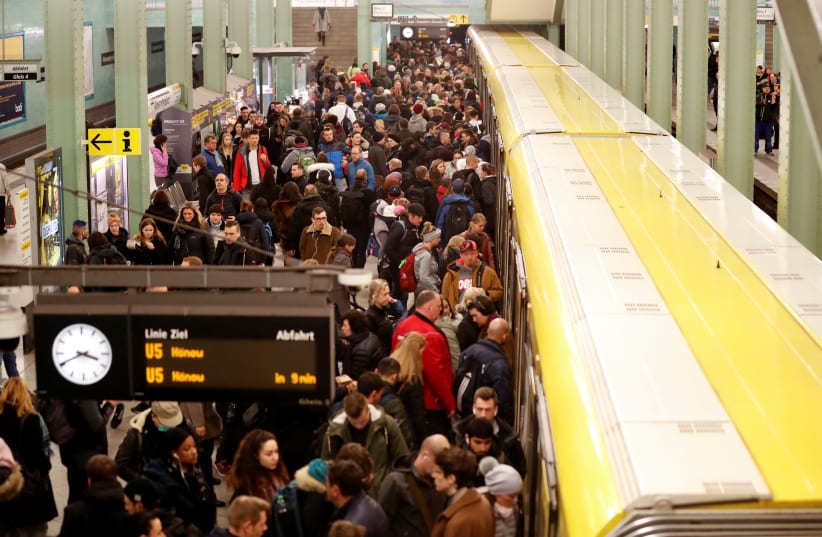 Commuters wait for an U-Bahn underground train at Alexanderplatz station as Berlin authorities took new measures to cancel events with over 1,000 people because of the coronavirus disease (COVID-19) in Berlin, Germany, March 11, 2020 (photo credit: REUTERS/FABRIZIO BENSCH)