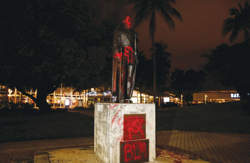  VANDALIZED STATUE of Christopher Columbus is seen in Miami in June.  (photo credit: MARCO BELLO/REUTERS)