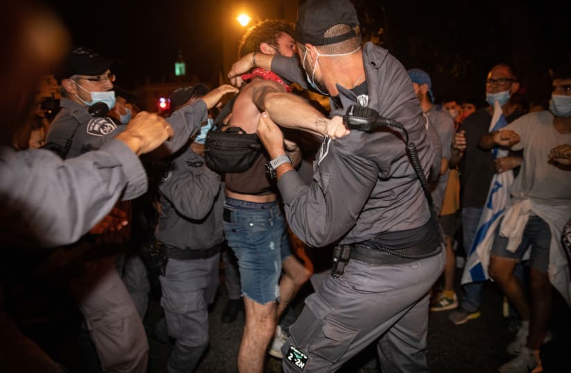 Police officers arrest a demonstrator during protests against Prime Minister Benjamin Netanyahu, Jerusalem, August 22, 2020 (photo credit: NOAM REVKIN FENTON/FLASH90)
