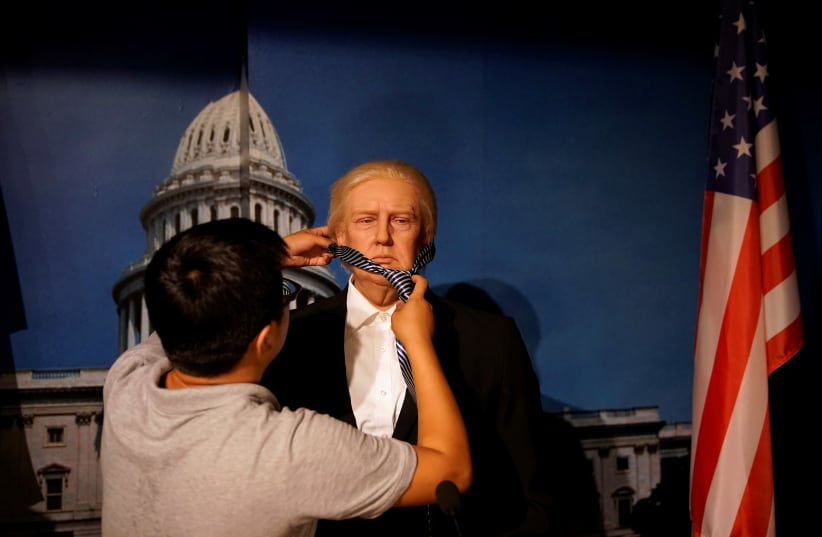 A technician demonstrates for the camera the assembling of a wax figure of US President Donald Trump at a wax museum of Shanghai Maiyi Arts, Shanghai, China, August 21, 2020 (photo credit: REUTERS/ALY SONG)