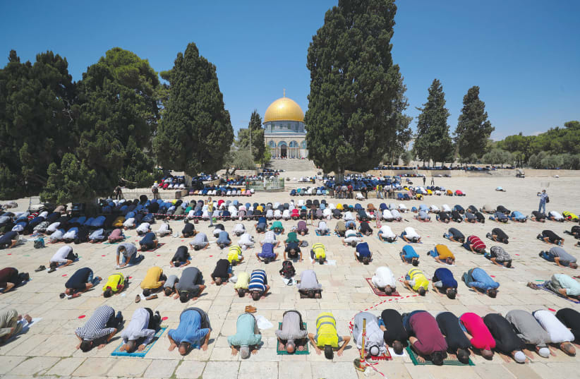 Muslims pray in front of the Dome of the Rock. (photo credit: AMMAR AWAD / REUTERS)