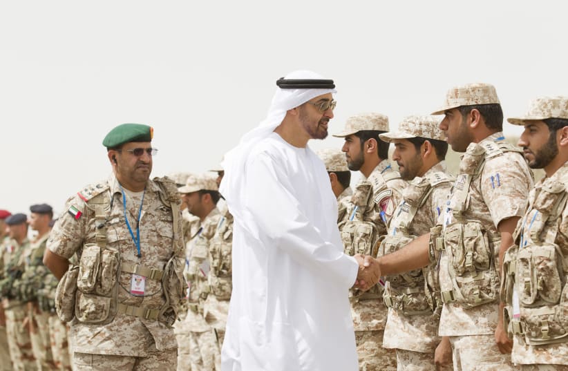 Abu Dhabi Crown Prince Sheikh Mohammed Bin Zayed Al Nahyan shakes hands with a member of the UAE armed forces during joint military manoeuvres between the UAE and the French army in the desert of Abu Dhabi May 2, 2012 (photo credit: REUTERS/WAM/HANDOUT)
