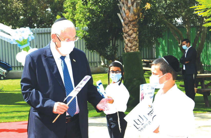 President Reuven Rivlin is greeted by students of Ben Ish Hayil Talmud Torah and Yeshivot in Rehovot, August 2020 (photo credit: AMOS BEN GERSHOM, GPO)
