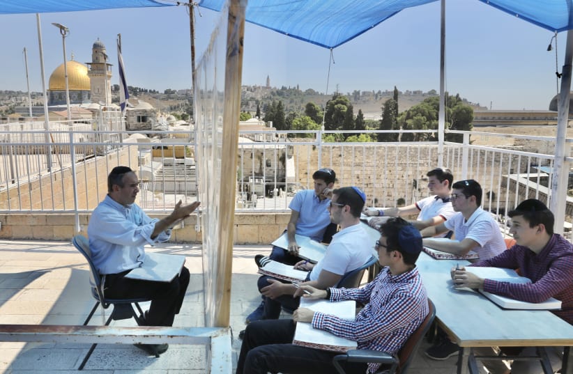 A yeshiva in the Old City of Jerusalem studies overlooking the Western Wall, students in quarantine (photo credit: MARC ISRAEL SELLEM)