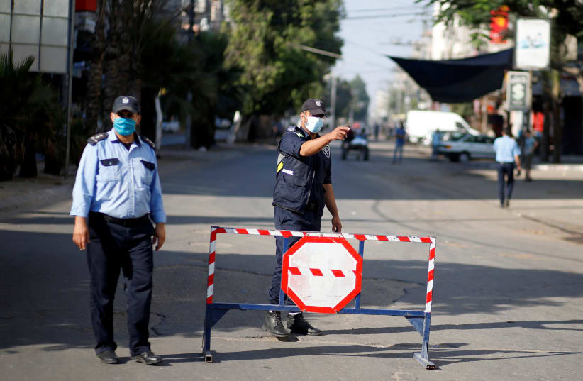 Gaza reports first COVID-19 cases outside quarantine areas, declares lockdown (photo credit: MOHAMMED SALEM/ REUTERS)