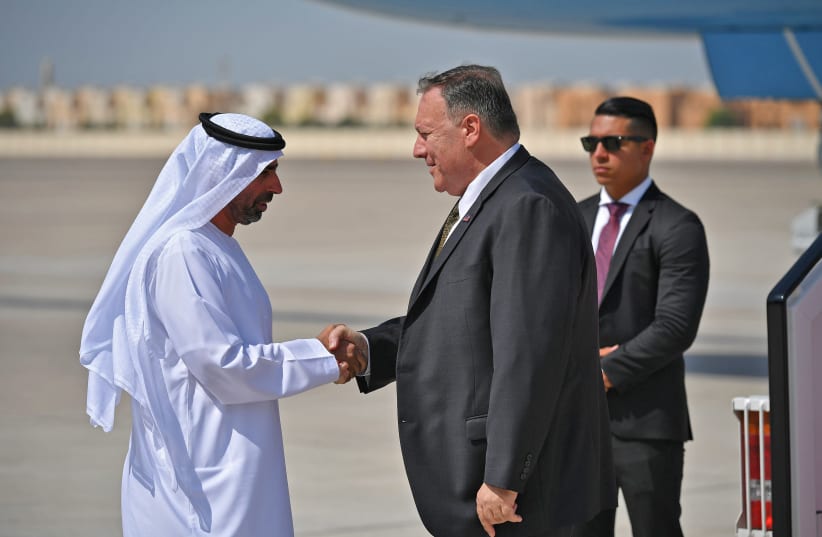 US Secretary of State Mike Pompeo (C) shakes hands with an unidentified UAE official upon his arrival at al-Bateen Air Base in Abu Dhabi, United Arab Emirates September 19, 2019. (photo credit: REUTERS)