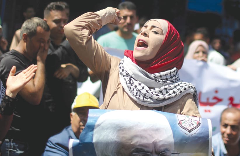 A woman shouts slogans during a demonstration against the UAE’s deal with Israel to normalize relations, in Gaza City, August 19, 2020 (photo credit: MOHAMMED SALEM/ REUTERS)