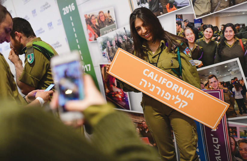 IDF SOLDIERS attend a Tel Aviv event last year. The Sar-El program’s army volunteers tend to be both older and from foreign countries (photo credit: TOMER NEUBERG/FLASH90)