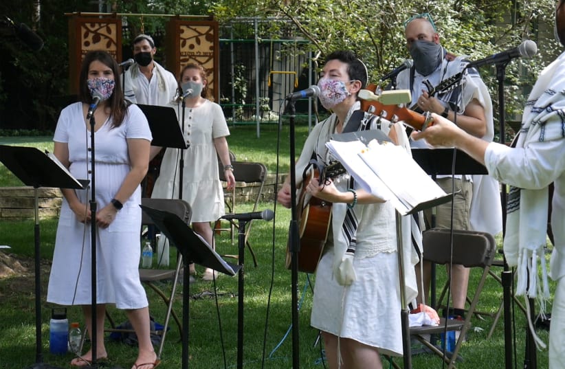 To create a pre-recorded online service, Rabbi Lizzi Heydemann, center, and musicians and singers from Mishkan Chicago recorded the songs and prayers of the High Holidays in August (photo credit: COURTESY OF SEE3 DIGITAL EVENTS)
