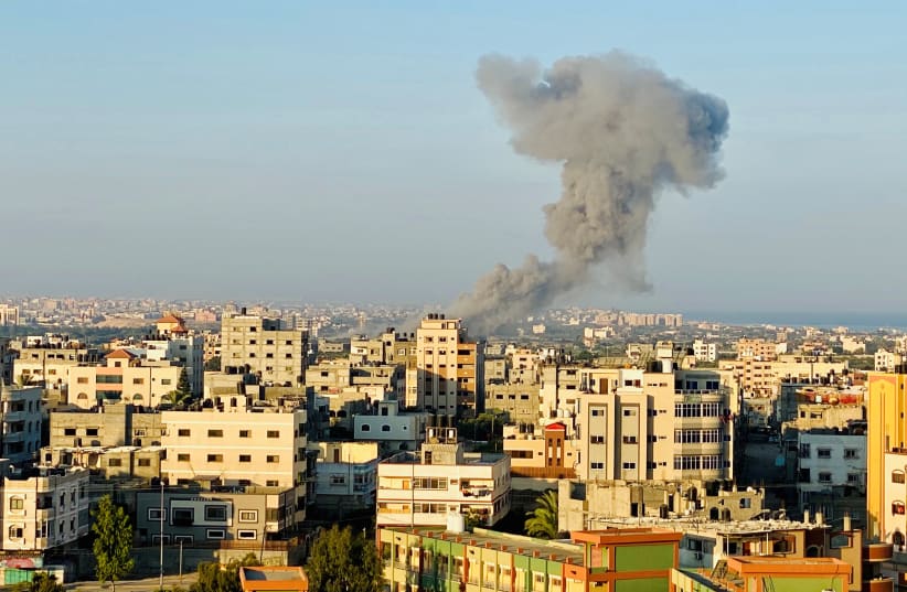 Smoke rises following an Israeli air strike in Gaza Strip August 28, 2020 (photo credit: REUTERS/MOHAMMED SHANA)