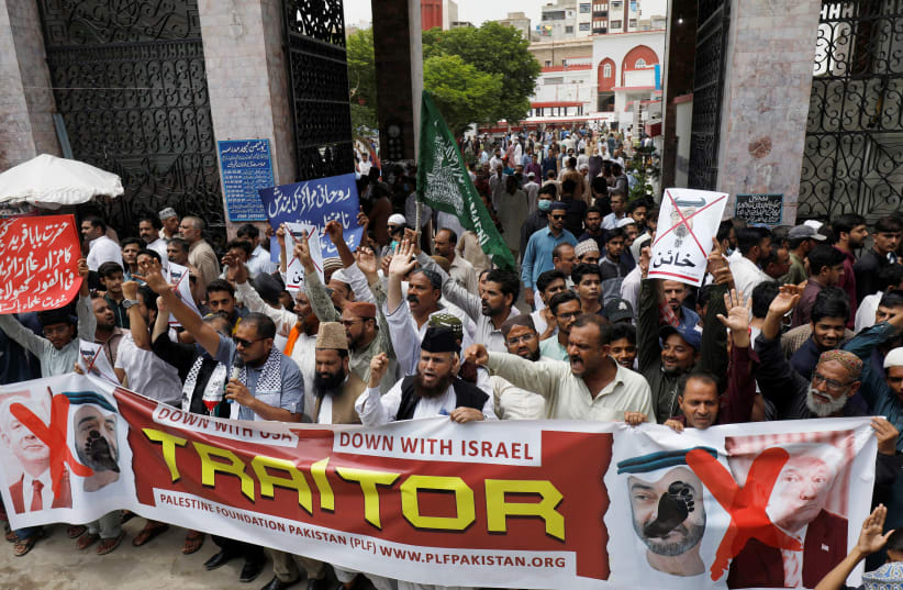 Supporters of the Palestine Foundation Pakistan (PLF) chant slogans as they carry a banner in support of Palestinian people to condemn the diplomatic agreement between the United Arab Emirates (UAE) and Israel, during a protest in Karachi, Pakistan August 21, 2020 (photo credit: REUTERS/AKHTAR SOOMRO)