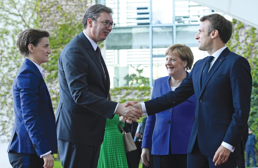 GERMAN CHANCELLOR Angela Merkel and French President Emmanuel Macron welcome Serbian President Aleksandar Vucic and Serbian Prime Minister Ana Brnabic at the Chancellery in Berlin last year. (photo credit: ANNEGRET HILSE / REUTERS)