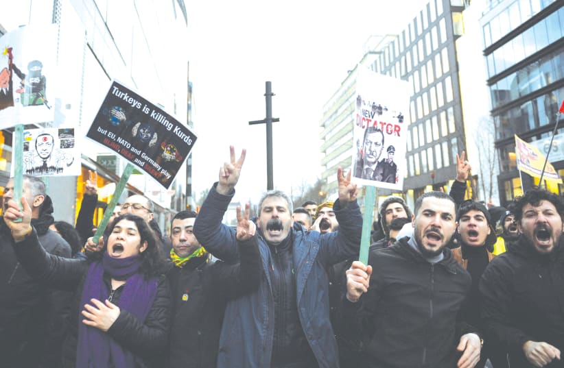 DEMONSTRATORS PROTEST a visit of Turkey’s President Recep Tayyip Erdogan in Brussels, March 2020. (photo credit: JOHANNA GERON/REUTERS)