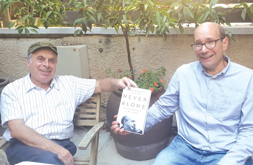 Natan Sharansky (left) and Gil Troy receive the first copies of their book ‘Never Alone: Prison, Politics and My People.’ (photo credit: LARISSA RUTHMAN)