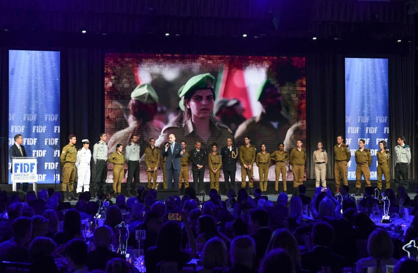 US and Israeli soldiers together onstage at the 2019 FIDF National Gala Dinner in NY (photo credit: SHACHAR AZRAN)