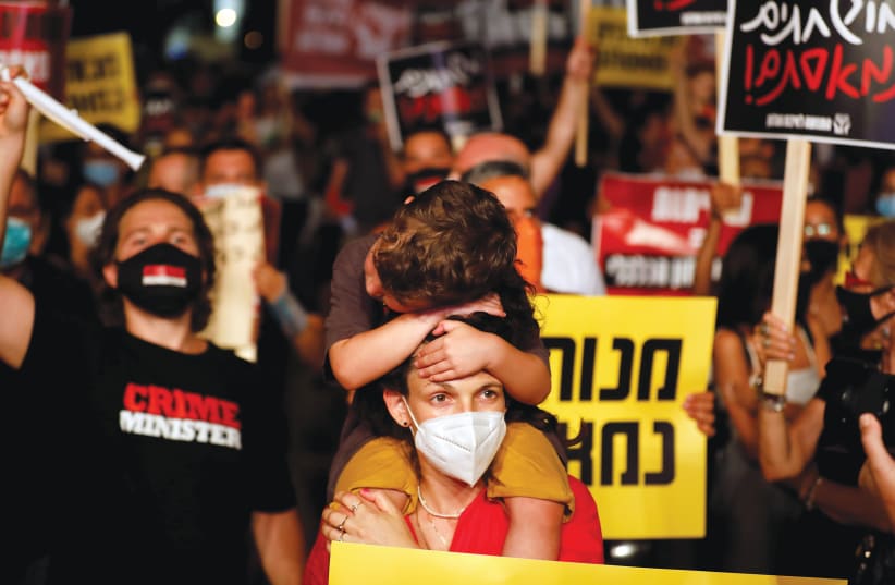 DEMONSTRATORS PROTEST the government’s handling of the coronavirus pandemic, in Tel Aviv on July 18. (photo credit: AMIR COHEN/REUTERS)