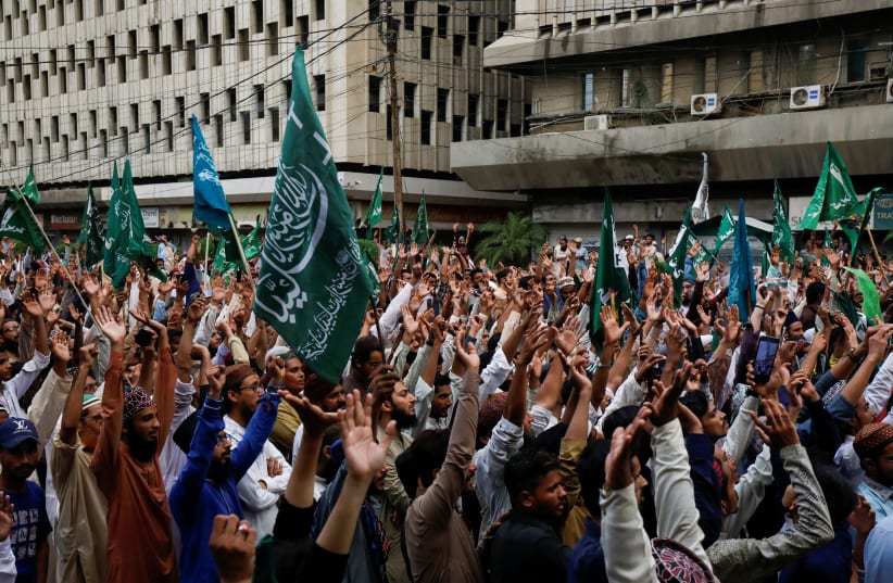 Supporters of religious and political party Tehreek-e-Labaik Pakistan (TLP) wave as they chant slogans against the satirical French weekly newspaper Charlie Hebdo, which reprinted a cartoon of the Prophet Mohammad, during a protest in Karachi, Pakistan September 4, 2020 (photo credit: REUTERS/AKHTAR SOOMRO)