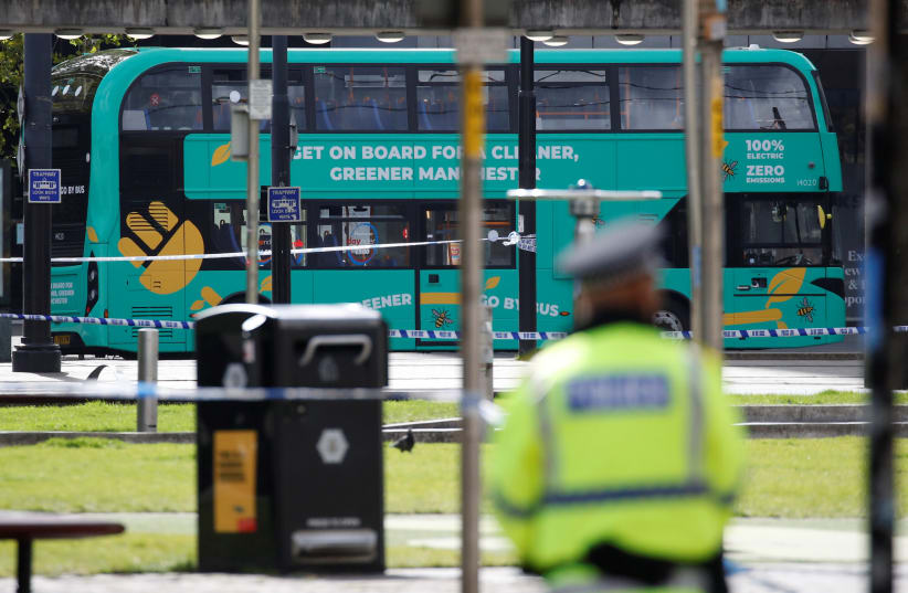 A bus is seen inside the security cordon after a suspect package was found, in Manchester city centre, Britain September 5, 2020 (photo credit: REUTERS/PHIL NOBLE)