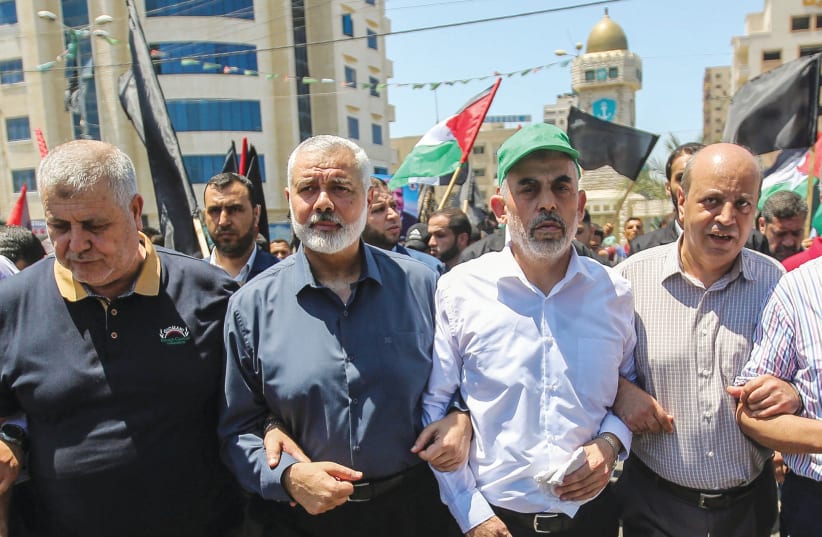 HAMAS LEADERS Ismail Haniyeh and Yahya Sinwar march to protest US President Donald Trump’s ‘Deal of the Century,’ in Gaza City in June 2019. (photo credit: HASSAN JEDI/FLASH90)