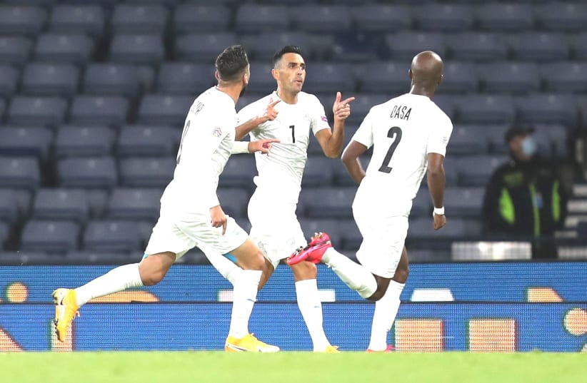 ISRAEL STRIKER Eran Zahavi (center) celebrates with his teammates after scoring a 73rd-minute goal in the blue-and-white’s 1-1 away draw with Scotland on Friday night in Nations League group action in Glasgow. (photo credit: REUTERS)