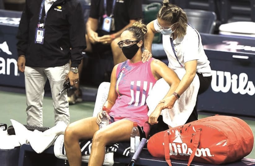 A MASKED Madison Keys receives courtside treatment during her first-round match last week at the decidedly different mid-pandemic 2020 US Open in New York (photo credit: USTA/COURTESY)