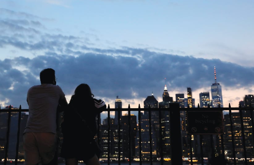 Gazing out at the altered skyline from a perch in Brooklyn, August 14 (photo credit: ANDREW KELLY / REUTERS)