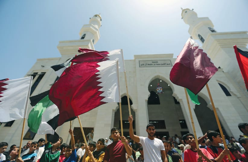 PALESTINIANS TAKE part in a rally in support of Qatar, inside Qatari-funded construction project ‘Hamad City,’ in the southern Gaza Strip. (photo credit: IBRAHEEM ABU MUSTAFA/REUTERS)