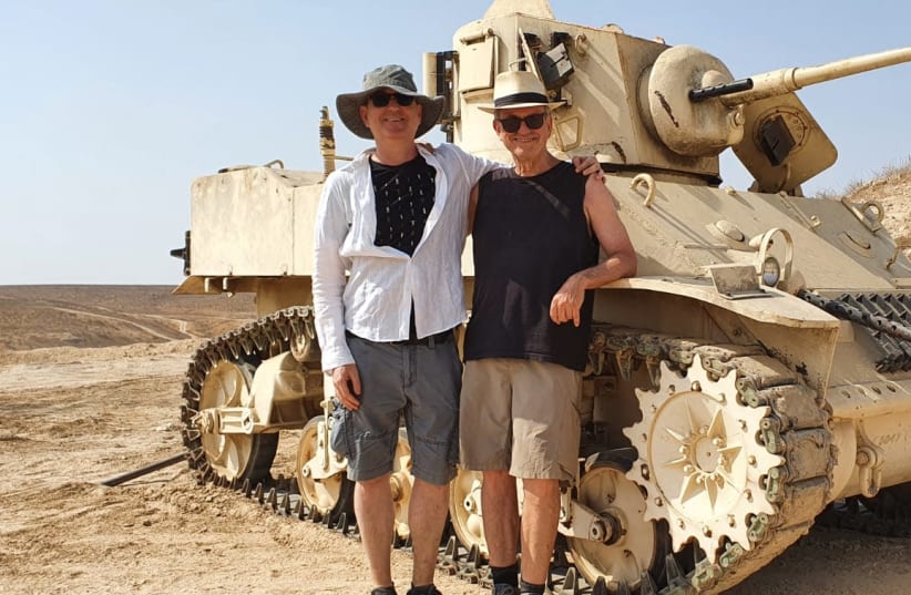Avi Nesher (right) and a crew member in front of a 1948 tank that has been restored for the movie “Portrait of Victory” (photo credit: Courtesy)