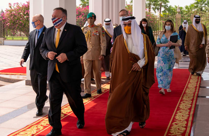 US Secretary of State Mike Pompeo walks with Bahrain Crown Prince Salman bin Hamad Al Khalifa during his visit to Manama, Bahrain, August 26, 2020. (photo credit: REUTERS)