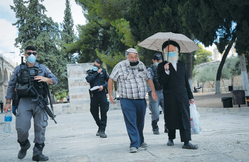 SECURITY FORCES escort a group of religious Jews during a visit to the Temple Mount last month. (photo credit: YOSSI ZAMIR/FLASH90)