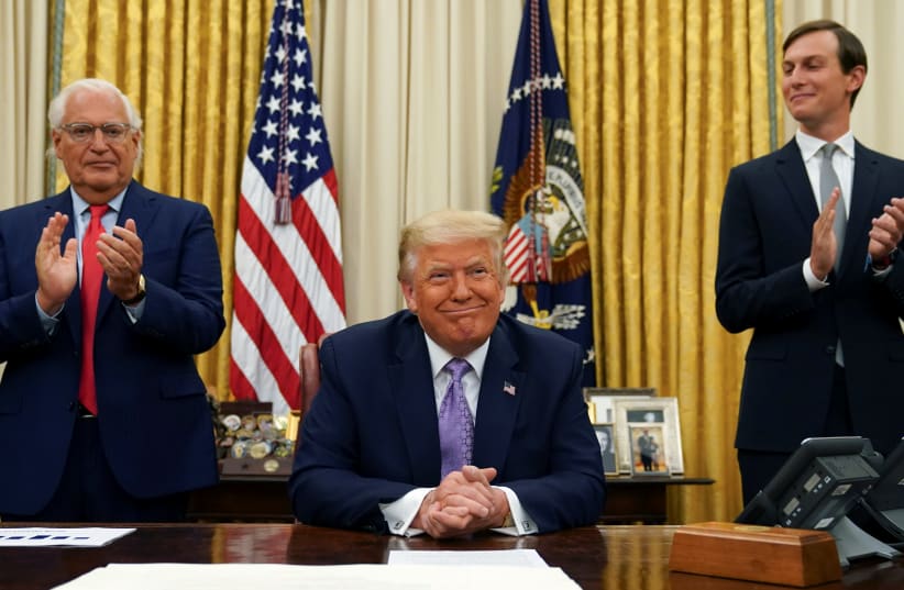 Flanked by US Ambassador to Israel David Friedman and White House senior adviser Jared Kushner, President Donald Trump announces a peace deal between Israel and the United Arab Emirates from the Oval Office of the White House in Washington on August 13, 2020.  (photo credit: KEVIN LAMARQUE/REUTERS)