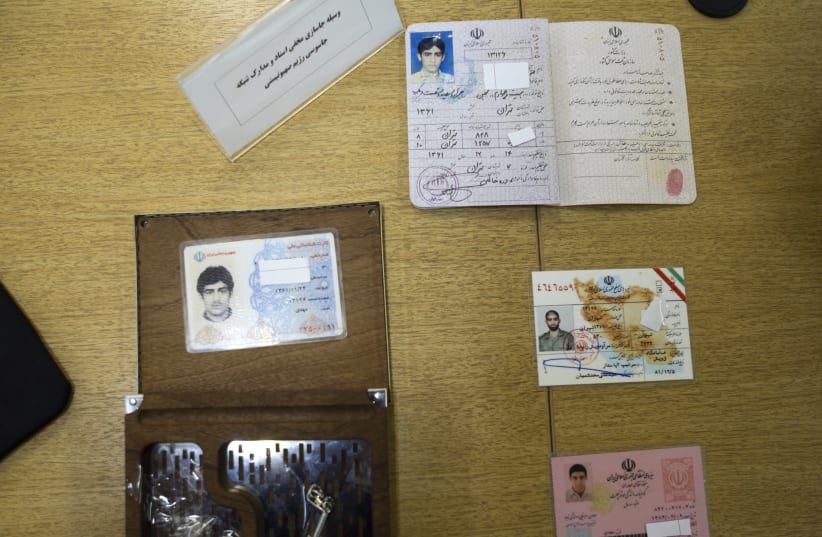 Iran's Intelligence Ministry display to the media what they said are fake identification cards which they confiscated as evidence after Iran's Intelligence Minister Heydar Moslehi's news conference in Tehran, January 11, 2011 (photo credit: REUTERS/MORTEZA NIKOUBAZL)