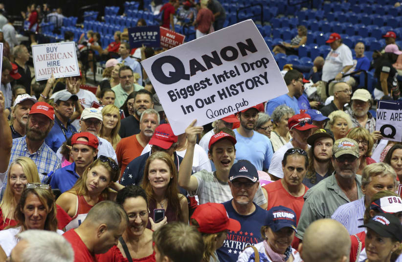 Trump supporters display QAnon posters at a 2018 rally in Florida. Recently, Latinos in the state have been inundated with anti-Semitic messages, many relating to the false QAnon conspiracy theory. (photo credit: THOMAS O'NEILL/NURPHOTO VIA GETTY IMAGES)