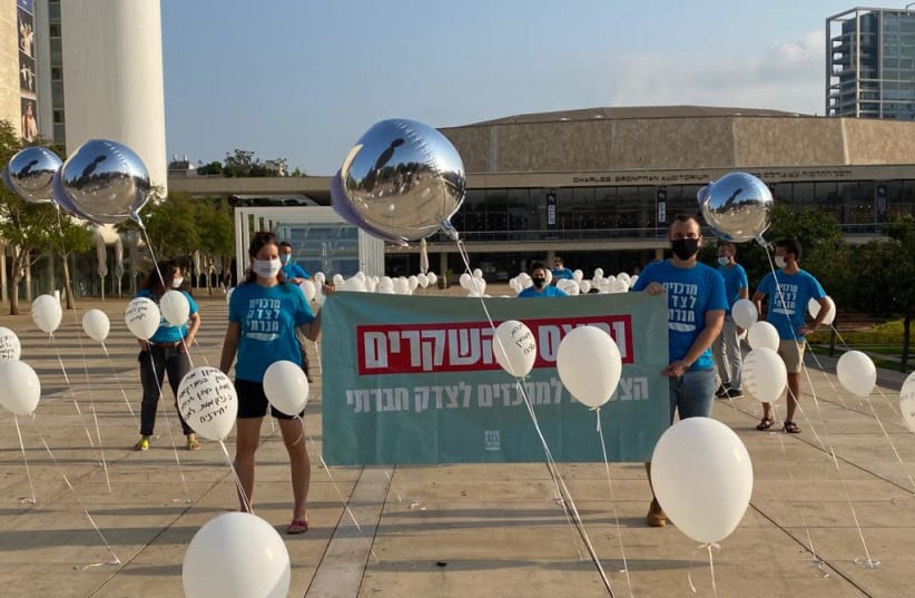 Protesters holding balloons displaying politicians' false promises at a protest on Habima Square, Tel Aviv. (photo credit: SHAI YEHEZKEL)