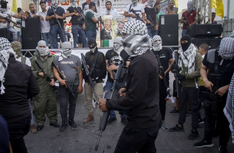 Palestinian militants of Fatah's al-Aqsa Martyrs Brigades take part in a military show as they protest against the deal between Israel and the UAE. August 22, 2020.  (photo credit: NASSER ISHTAYEH/FLASH90)