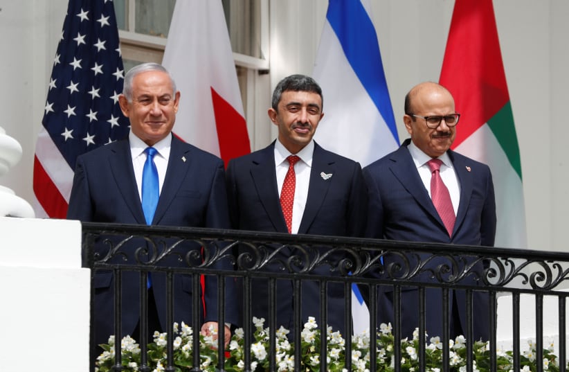 Israel's Prime Minister Benjamin Netanyahu, United Arab Emirates (UAE) Foreign Minister Abdullah bin Zayed and Bahrain's Foreign Minister Abdullatif Al Zayani standby prior to signing the Abraham Accords with US President Donald Trump at the White House in Washington, US, September 15, 2020. (photo credit: REUTERS/TOM BRENNER)