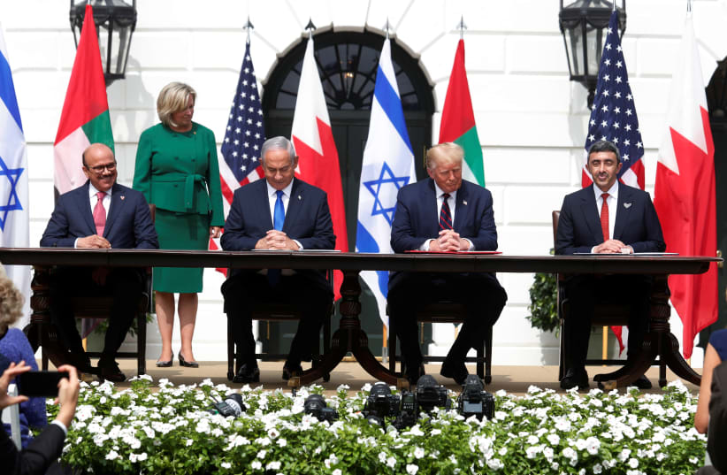 L to R: Bahrain’s Foreign Minister Abdullatif Al Zayani, Israel's Prime Minister Benjamin Netanyahu, US President Donald Trump and United Arab Emirates (UAE) Foreign Minister Abdullah bin Zayed participate in the signing ceremony of the Abraham Accords. September 15, 2020 (photo credit: REUTERS/TOM BRENNER)