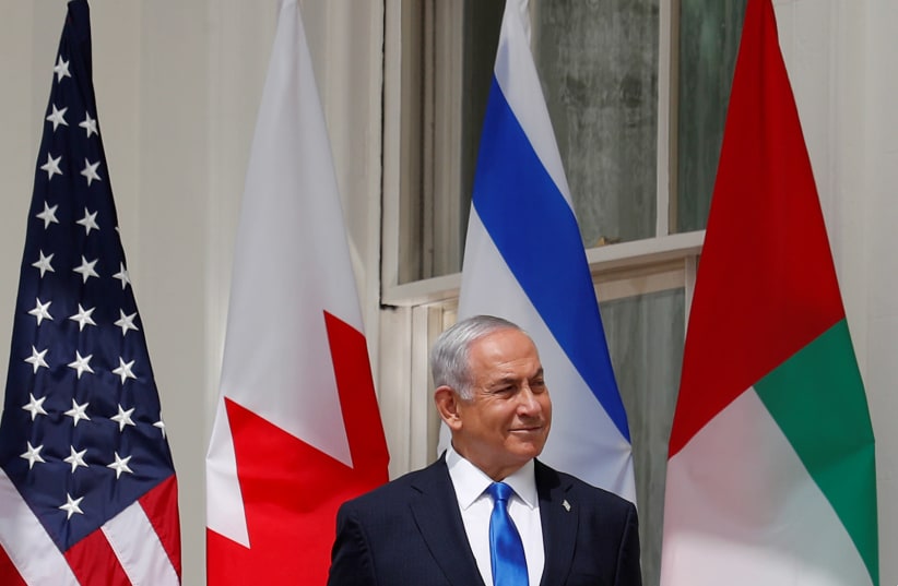 Israel's Prime Minister Benjamin Netanyahu istens prior to participating in the signing of the Abraham Accords at the White House in Washington, U.S., September 15, 2020 (photo credit: REUTERS//TOM BRENNER)